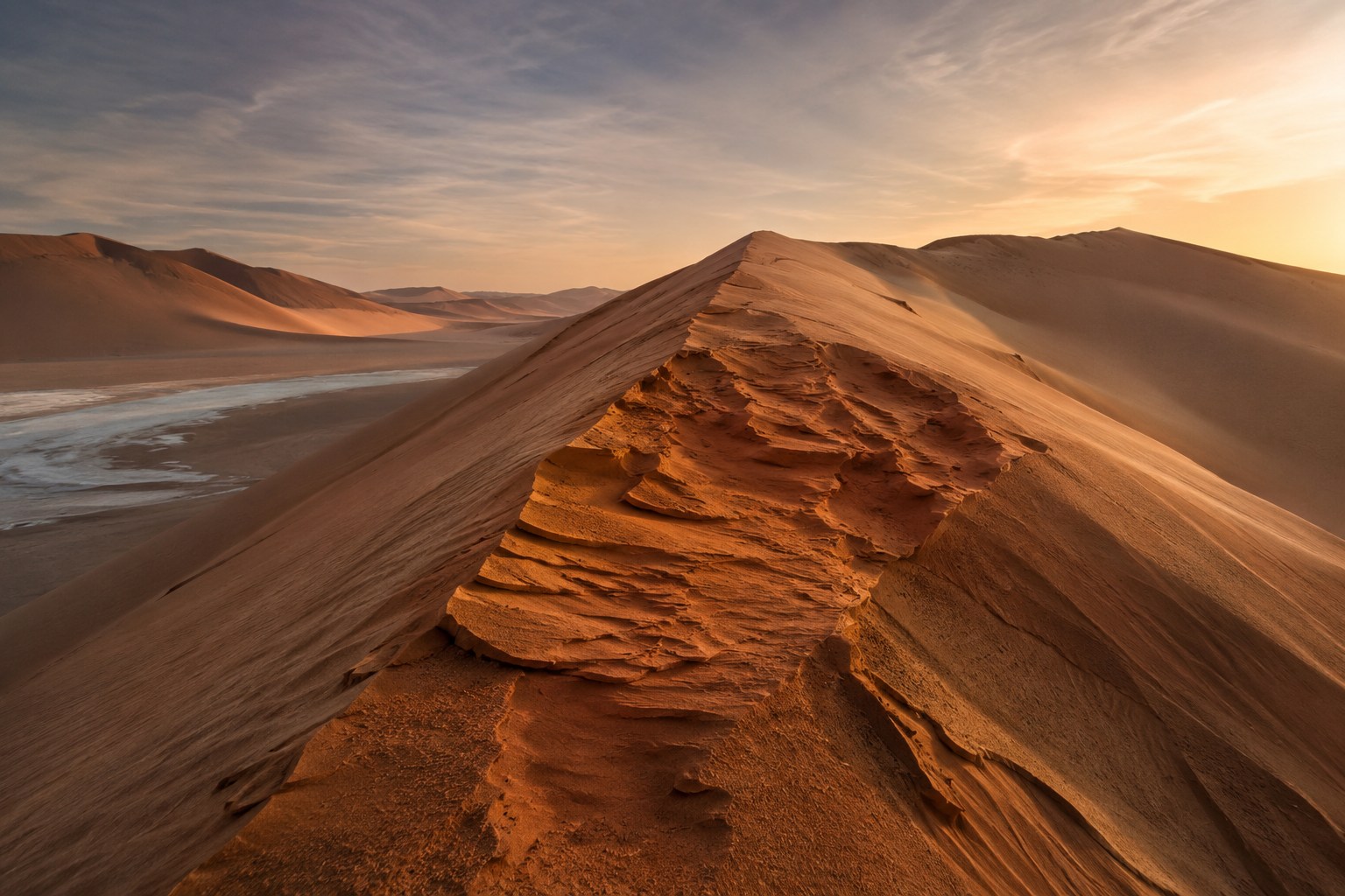 Editorial ground-level visualization looking along a wind-carved dune ridge in the Rubʿ al Khali